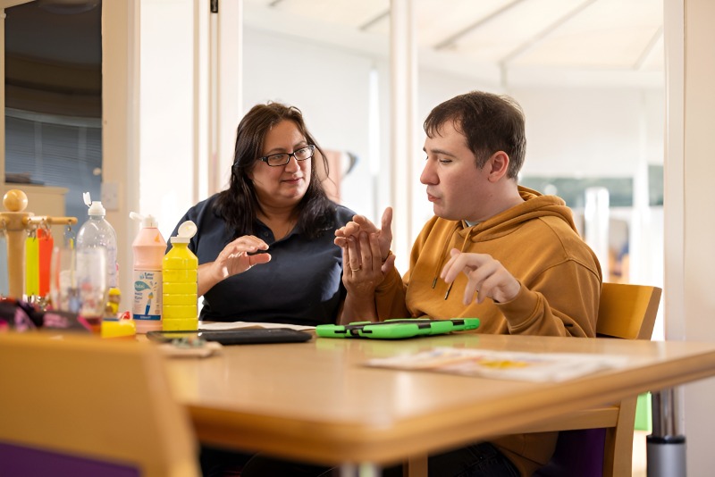 Support worker helping resident with daily life skills